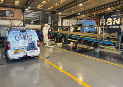 A&M Commercials HGV workshop transformation with custom demarcation lines and epoxy resin flooring.