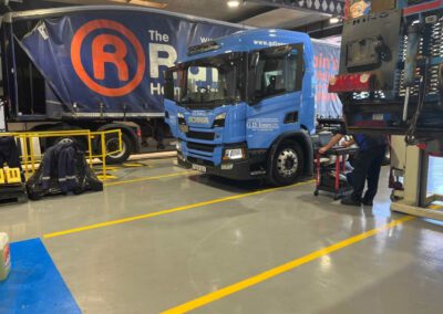 A&M Commercials HGV workshop transformation with custom demarcation lines and epoxy resin flooring.