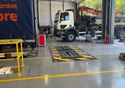 A&M Commercials HGV workshop transformation with custom demarcation lines and epoxy resin flooring.