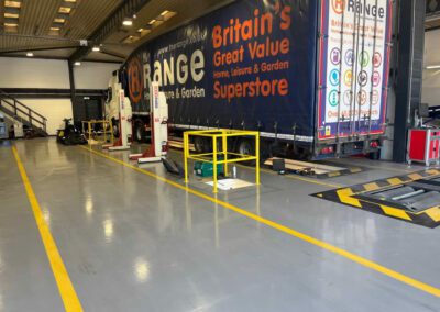 A&M Commercials HGV workshop transformation with custom demarcation lines and epoxy resin flooring.